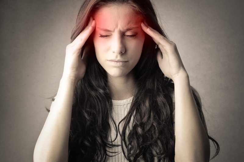 Chiropractor adjusting a patient's neck for tension headache relief through chiropractic care.