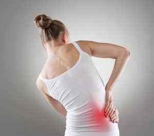 Chiropractor performing an adjustment to provide pinched nerve relief by realigning the spine.
