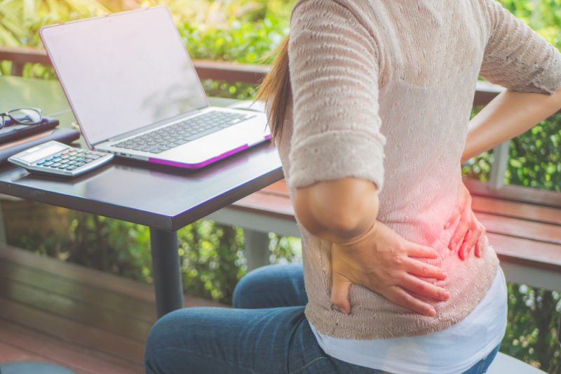 Chiropractor adjusting a desk worker's spine to relieve pain and improve posture.