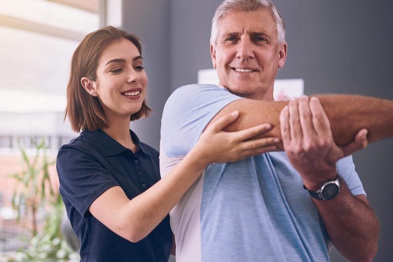 Chiropractor performing a gentle spinal adjustment to support recovery from surgery and improve mobility.