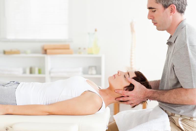 Chiropractor adjusting patient in Carlsbad office