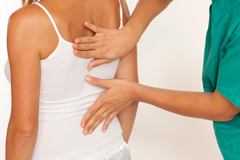 Chiropractor gently evaluating spinal misalignment post-accident