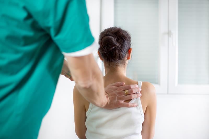 Chiropractor performing Gonstead adjustment in Bonita clinic
