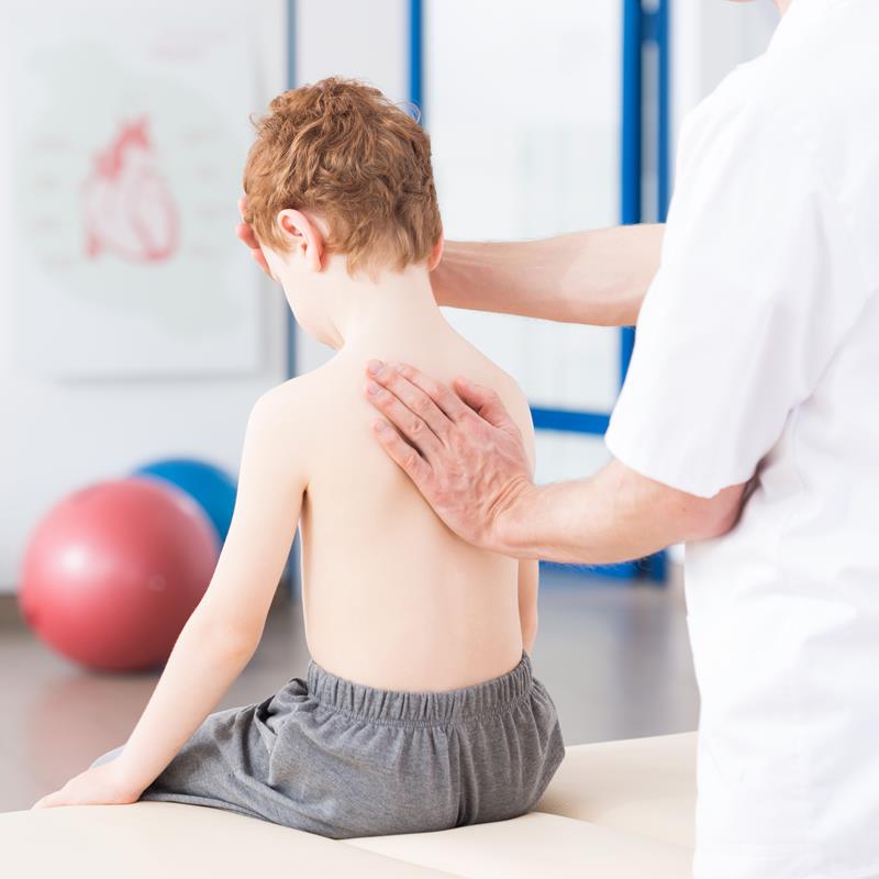 Infant receiving gentle chiropractic evaluation from practitioner