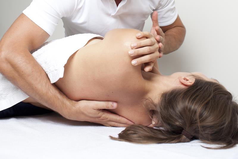 Pregnant woman receiving gentle chiropractic care on prenatal table
