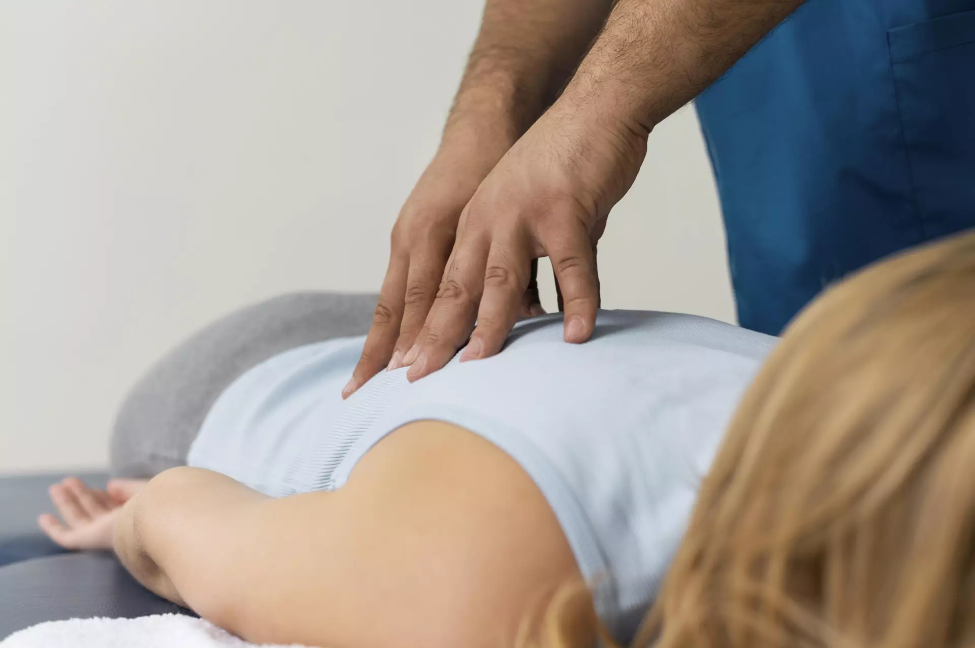 Adjustment of mid-back with patient prone