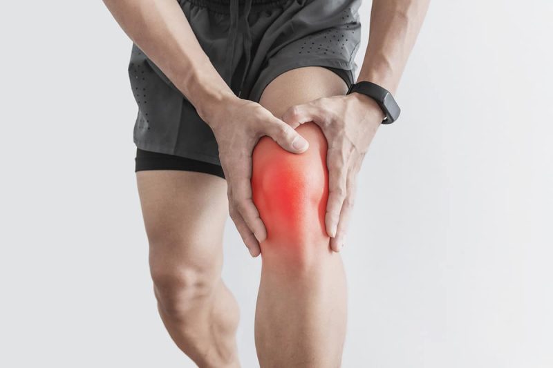 Person holding knee in pain