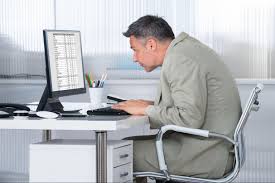 Person with visible forward head posture while working on computer