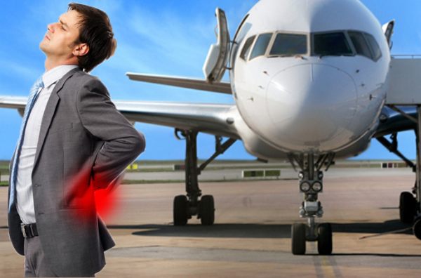 Traveler experiencing lower back pain during a long flight