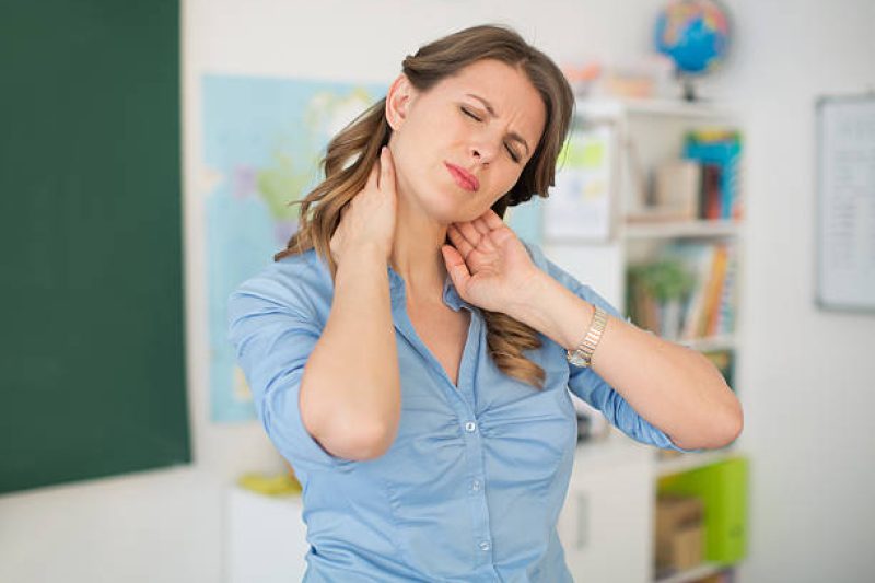 San Diego teacher experiencing neck and shoulder tension from classroom work