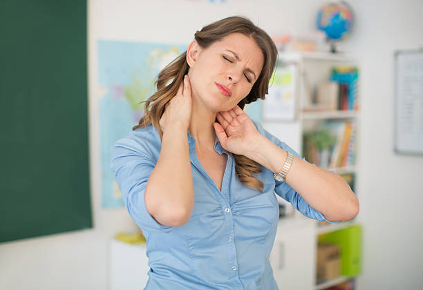 San Diego teacher experiencing neck and shoulder tension from classroom work